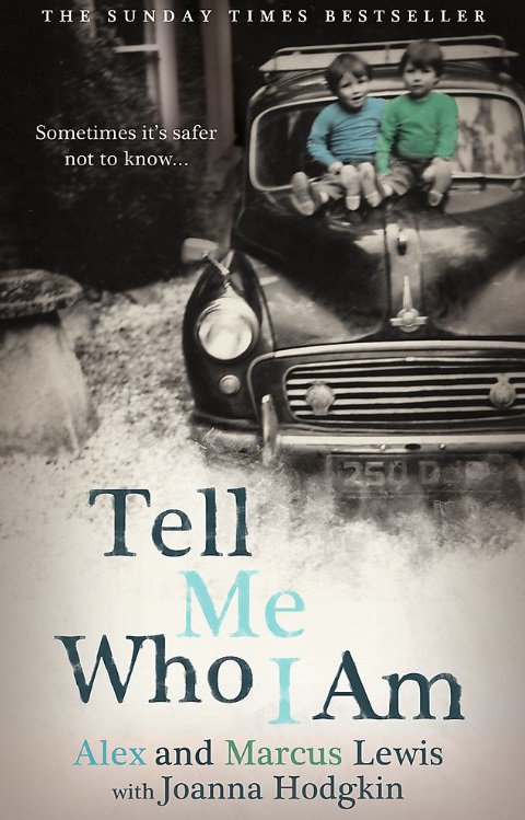 The cover of the book Tel Me Who I am, featuring two young boys, smiling as they sit on the bonnet of a car