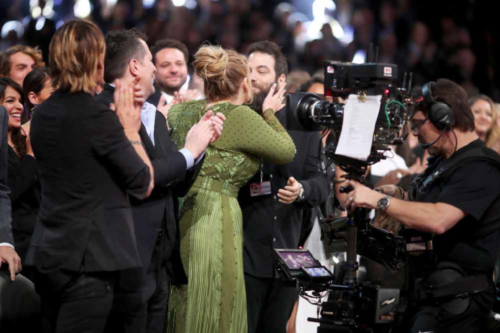 Adele kisses her husband at the Grammys
